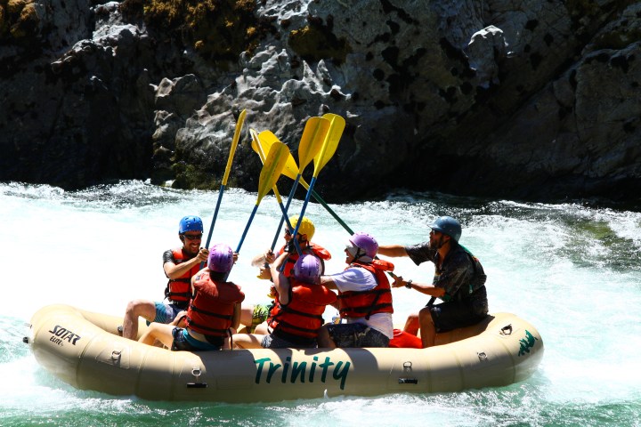 A group paddle high-fives on the Trinity River
