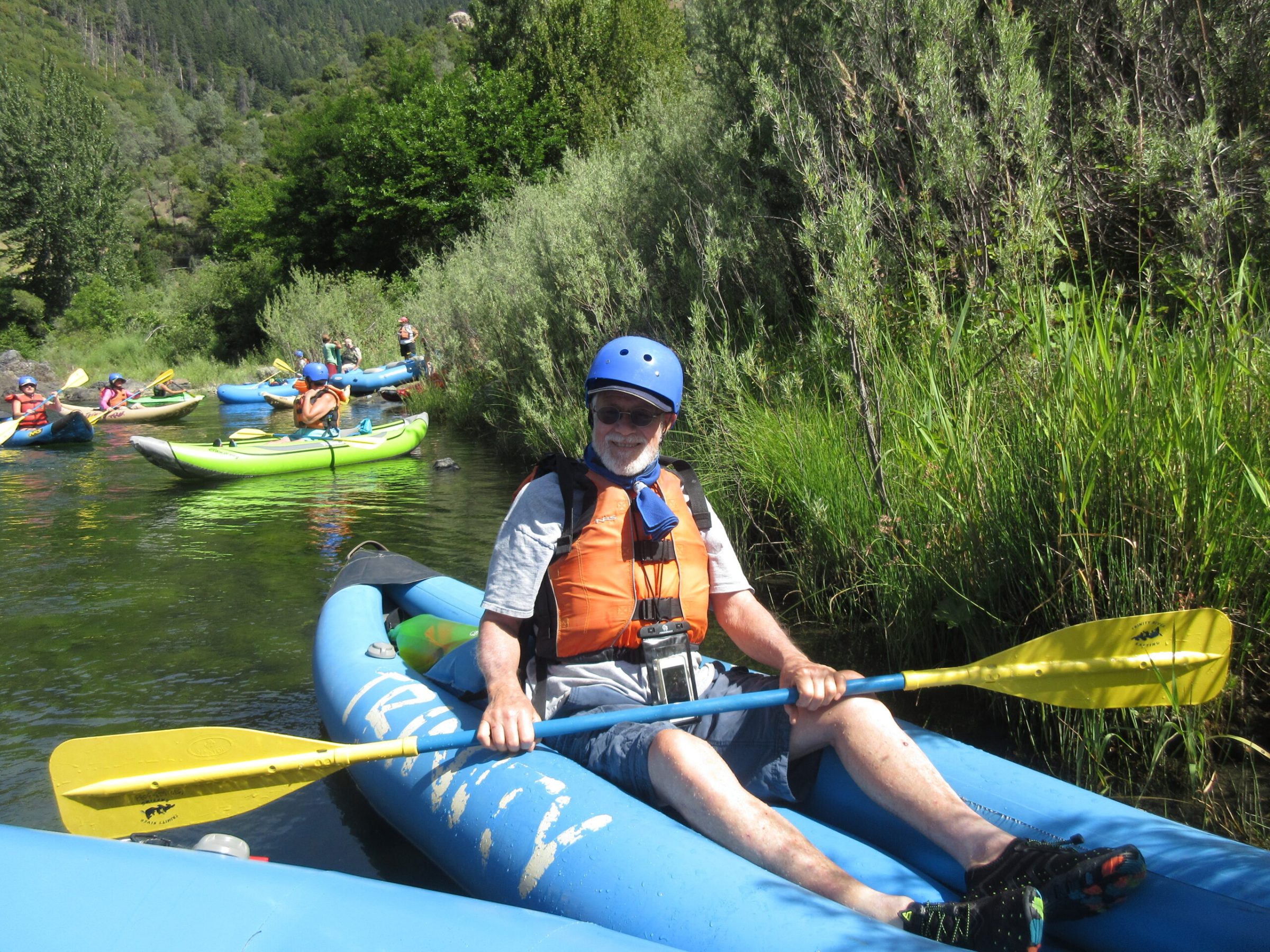 a young boy riding on a raft in a body of water