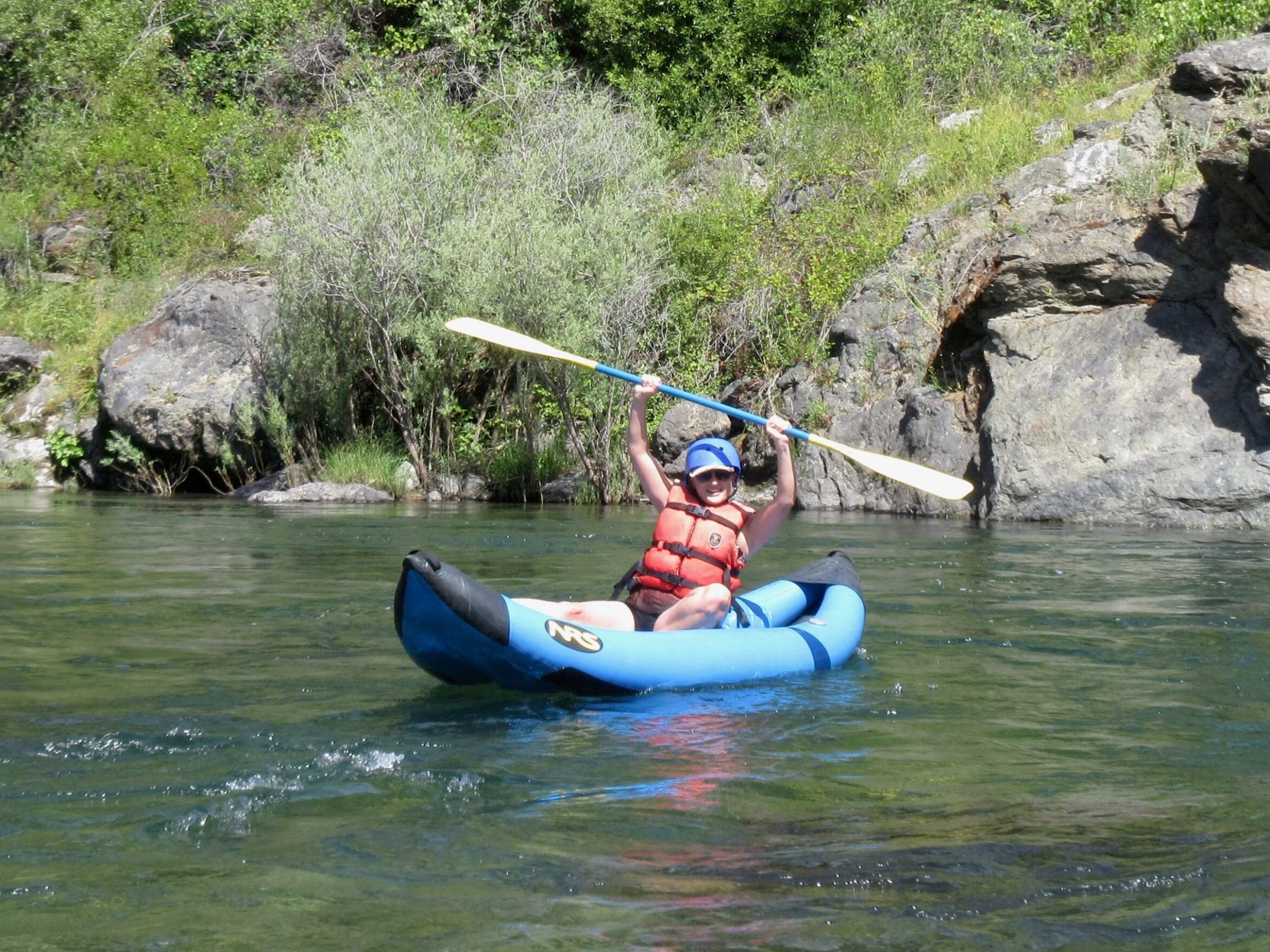 a person riding on the back of a boat in the water