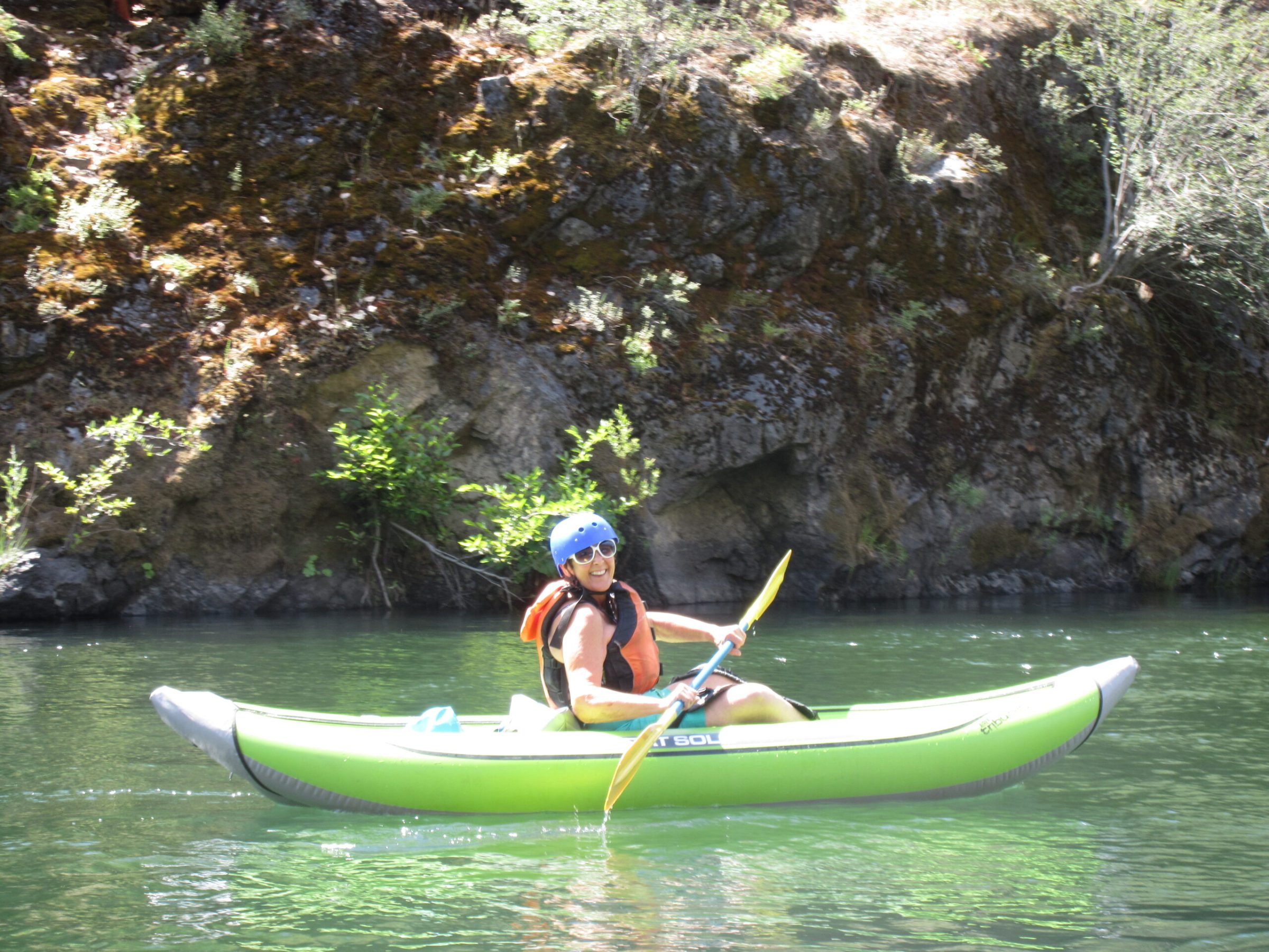 a man riding on the back of a boat in the water