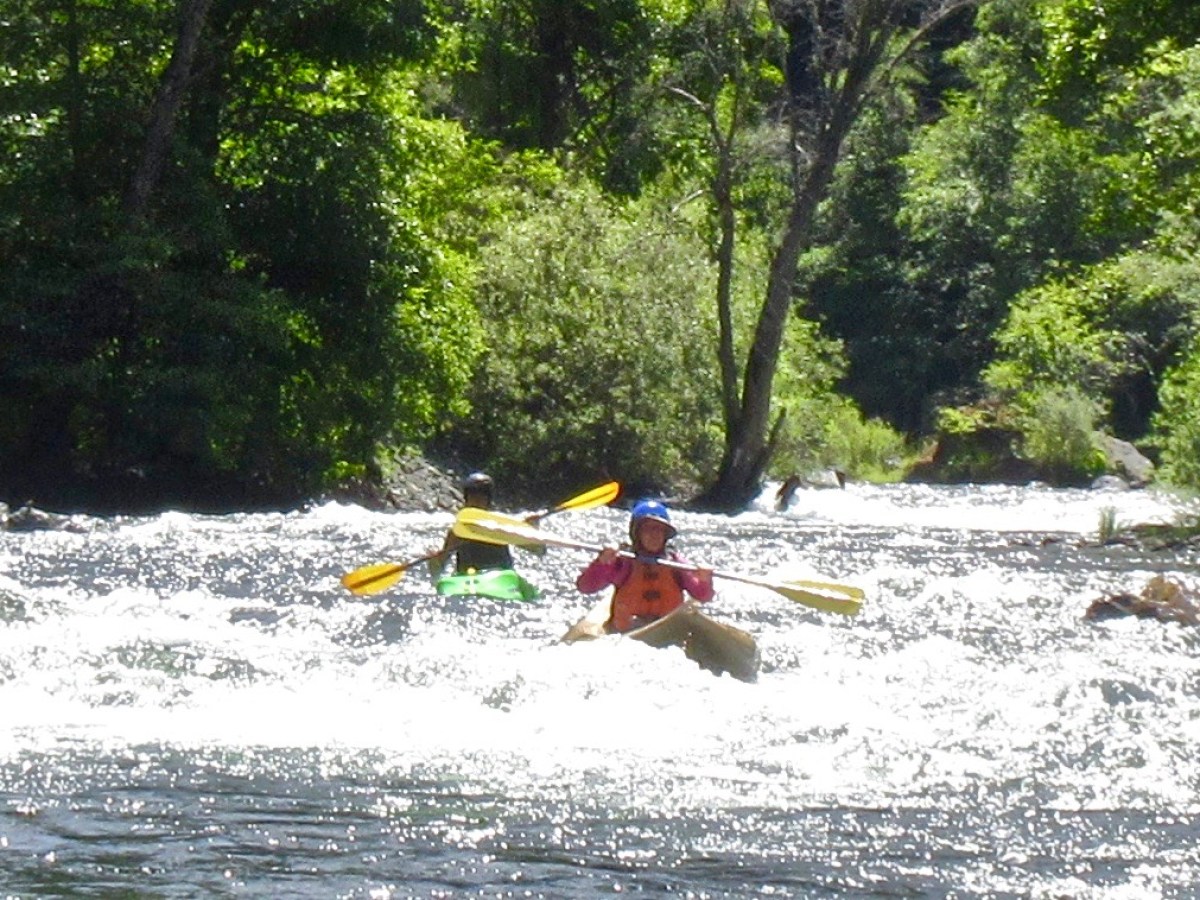 a man riding a snow board on a body of water