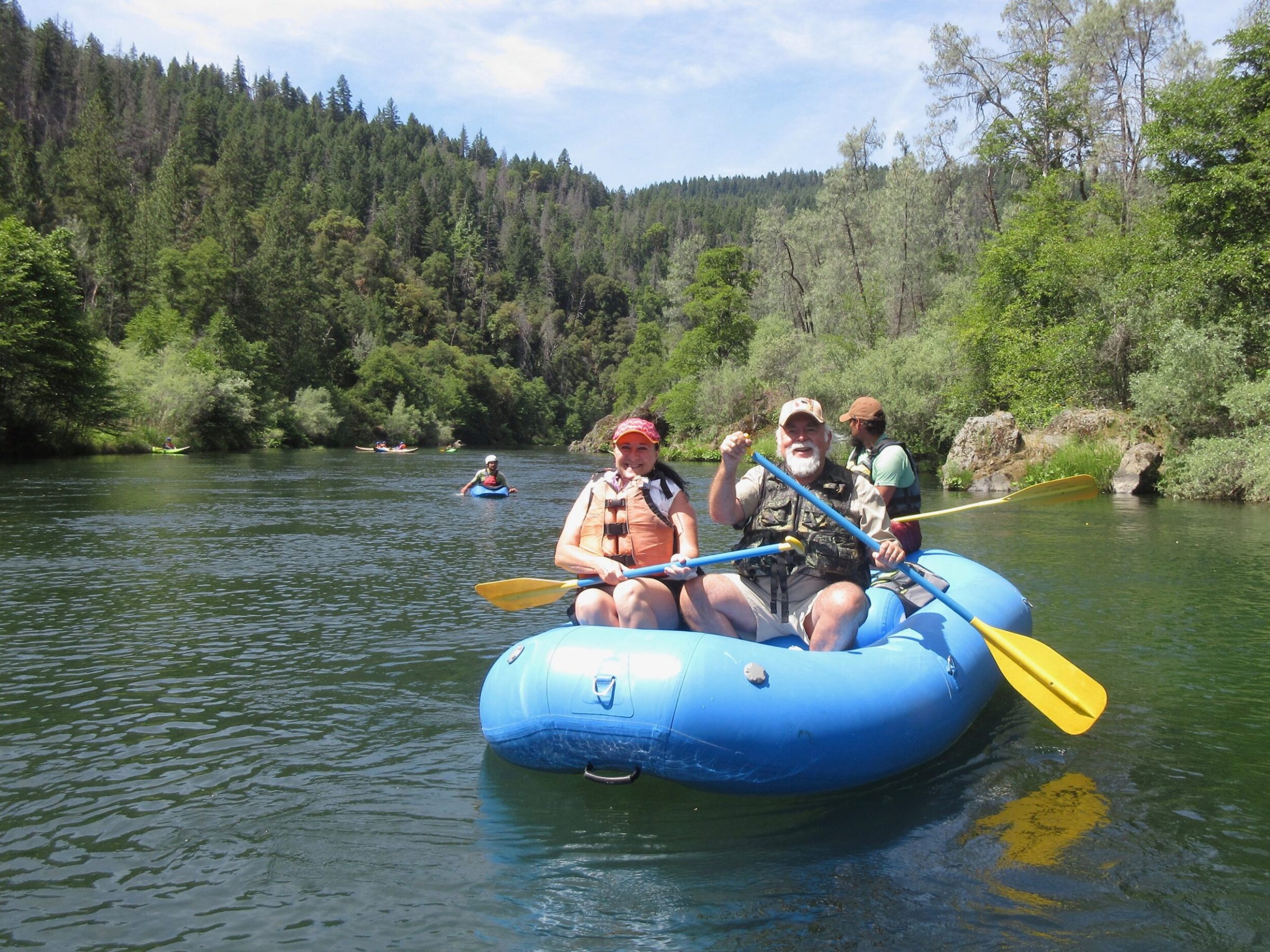 a group of people riding on a raft in a body of water