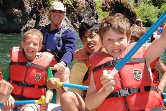 a group of people riding on the back of a boat